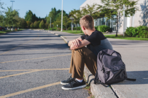 Stressed IB student sitting on kerb Stressed IB student sitting on kerb