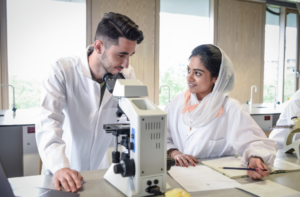 2 IB students with microscope
