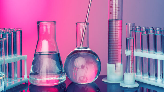 Science concept. Glass test tubes on red background